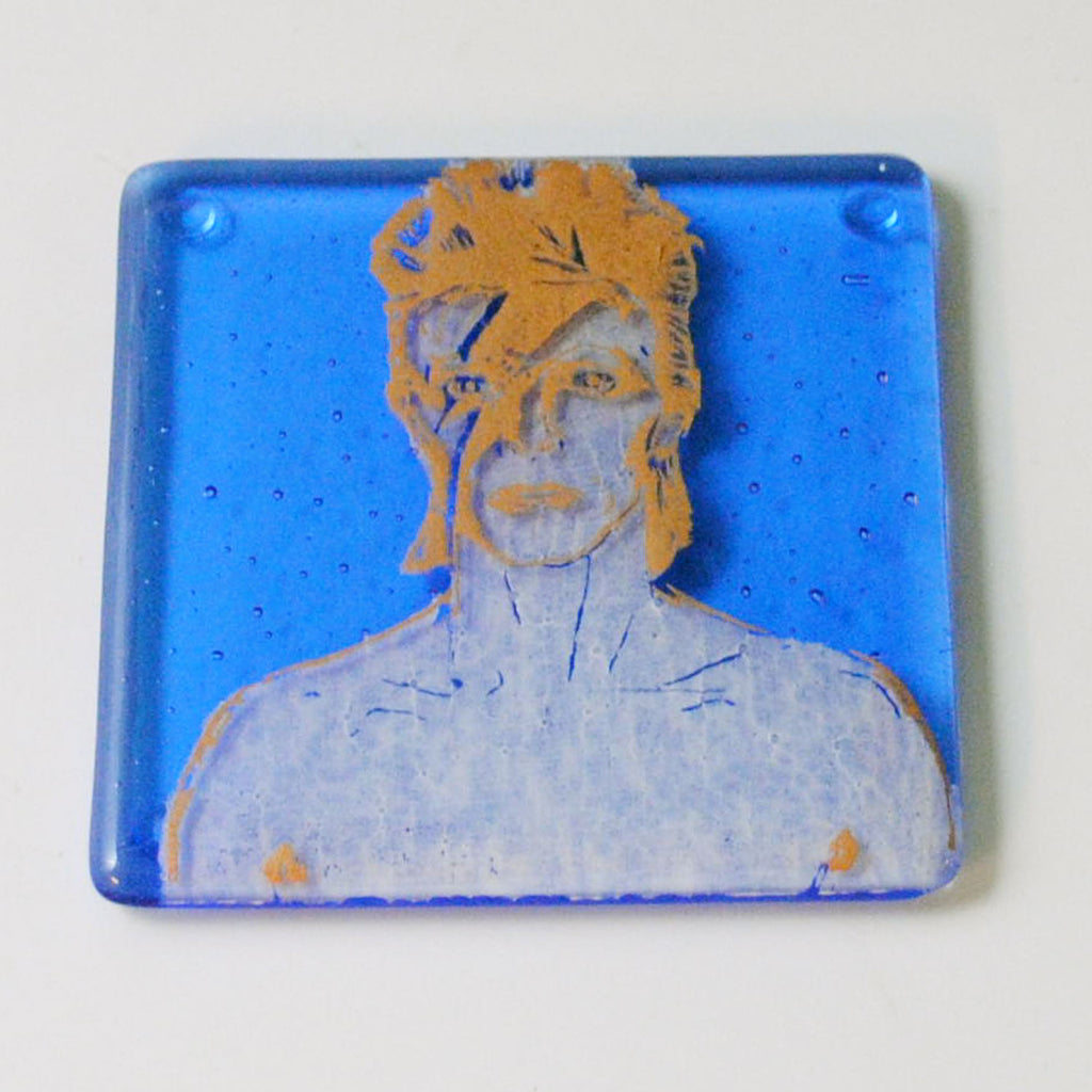 a picture of a man's face on a blue plate