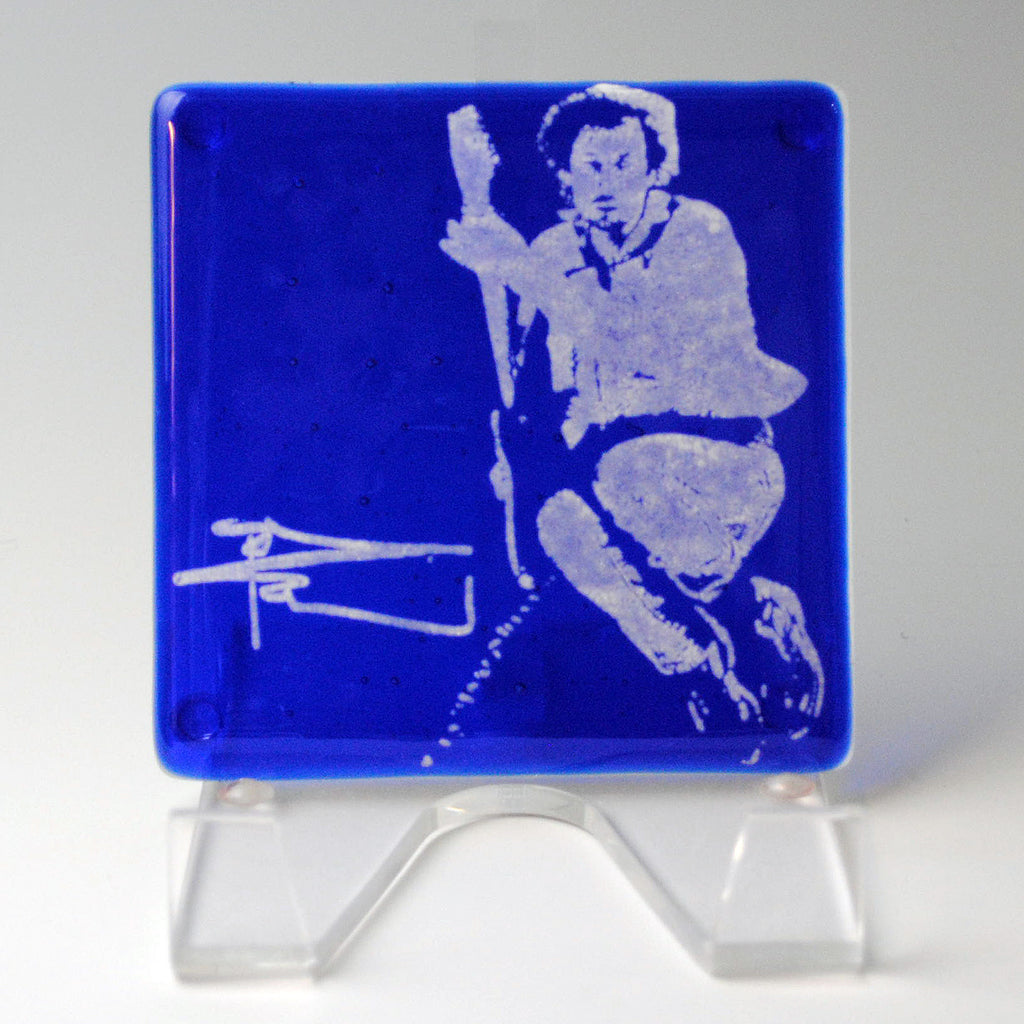 a blue glass with a picture of a man on it