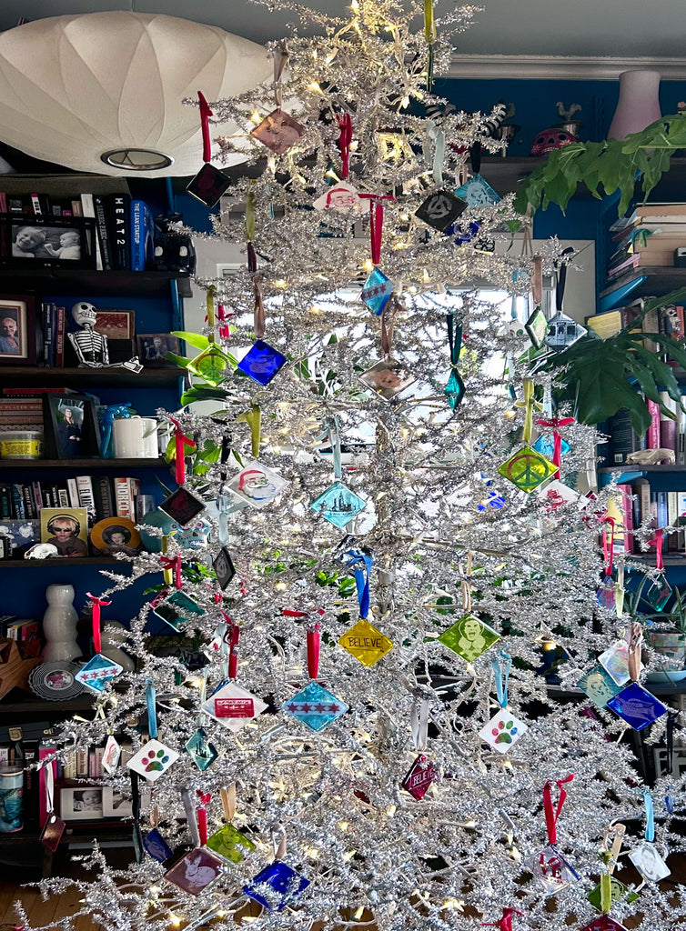 a white christmas tree with many ornaments hanging from it