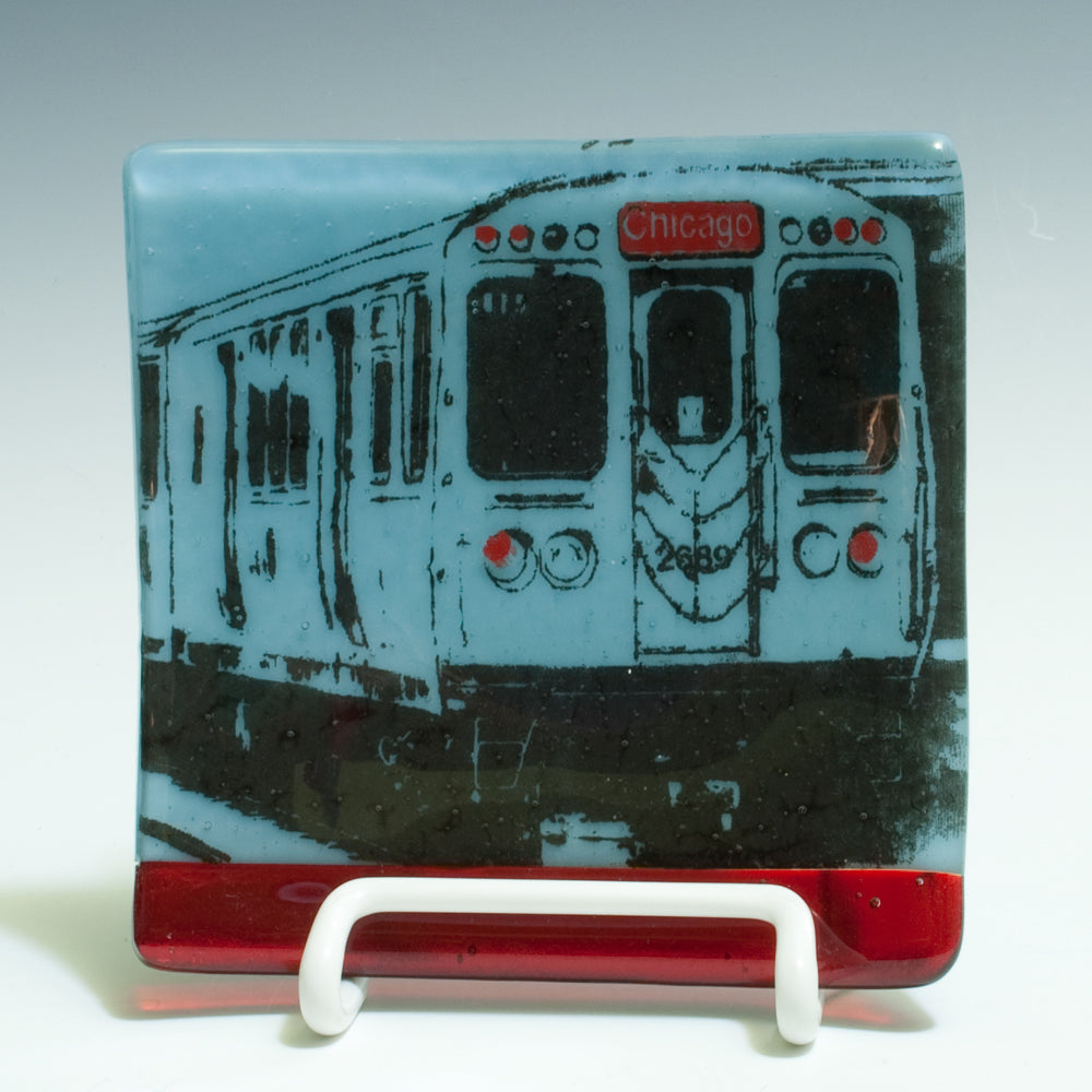 a glass coaster with a picture of a train on it