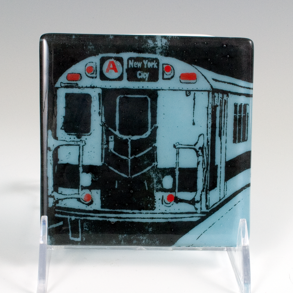 a glass coaster with a picture of a subway train