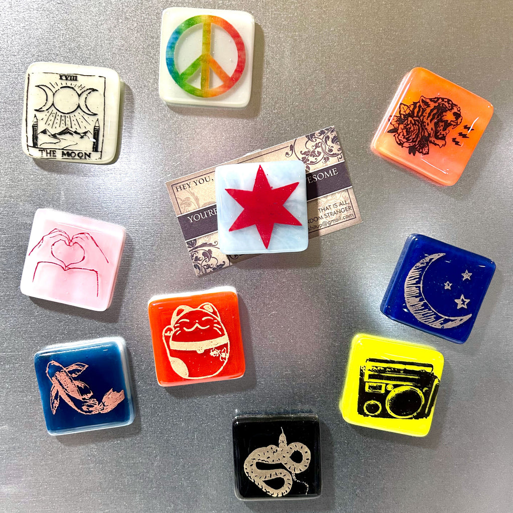 a bunch of magnets that are on a refrigerator