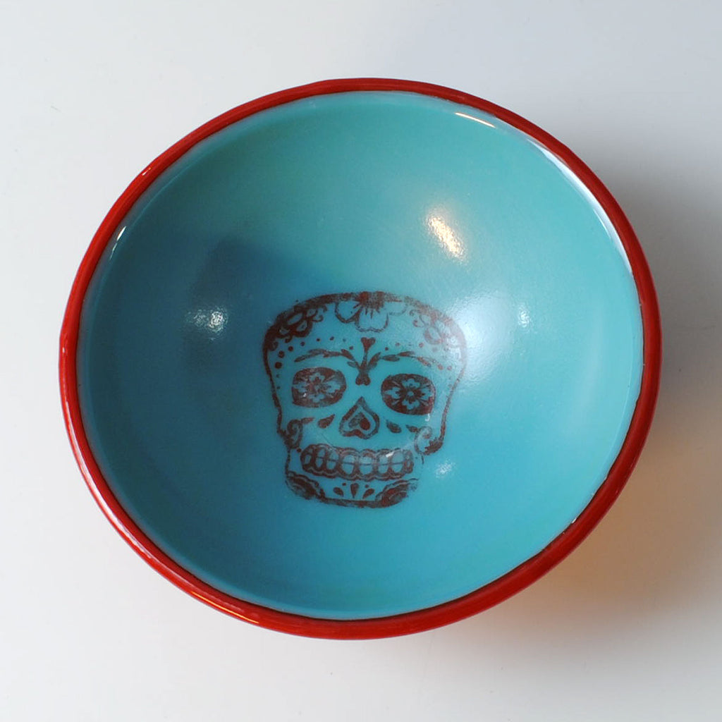 a blue bowl with a skull painted on it