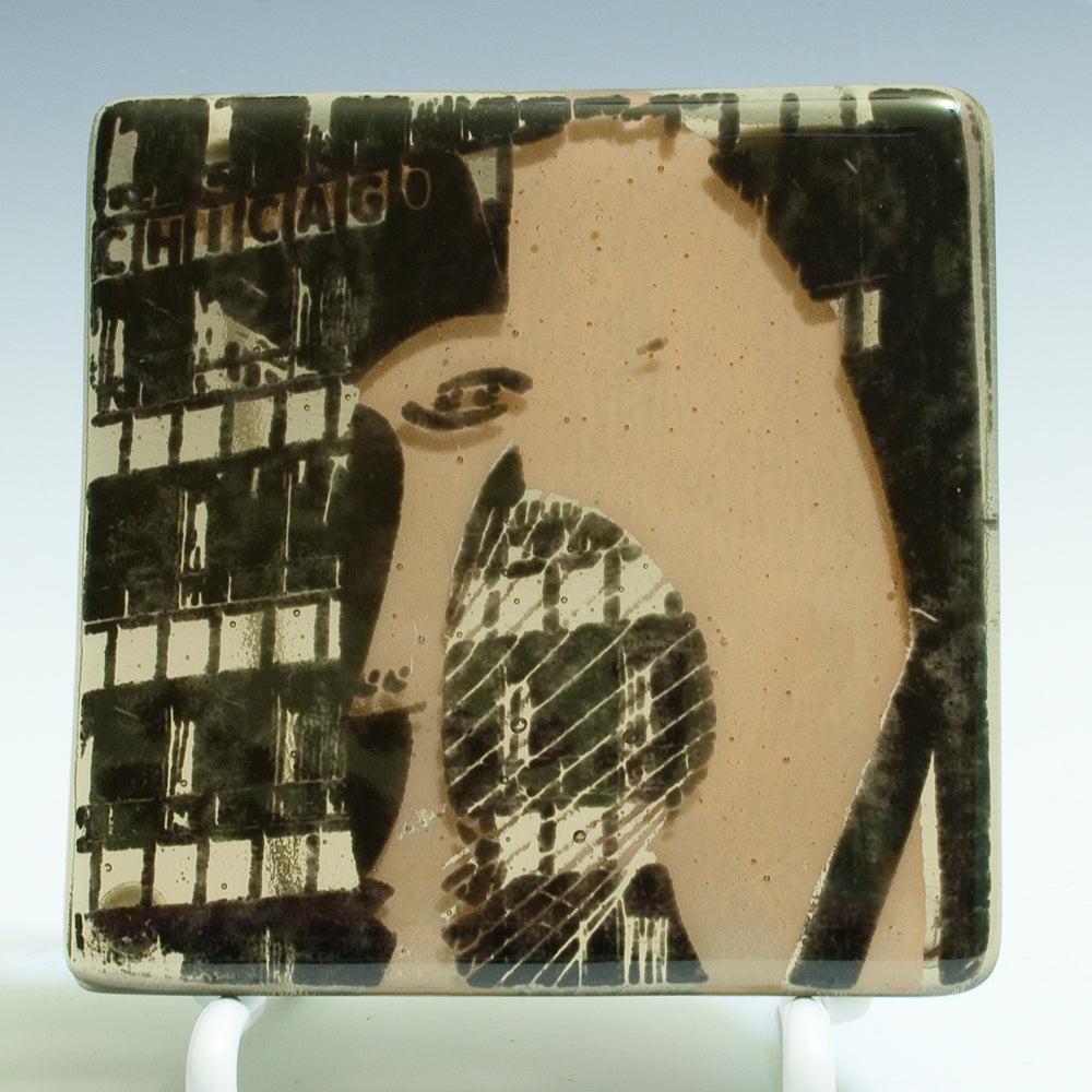 a close up of a tile with a picture of a woman