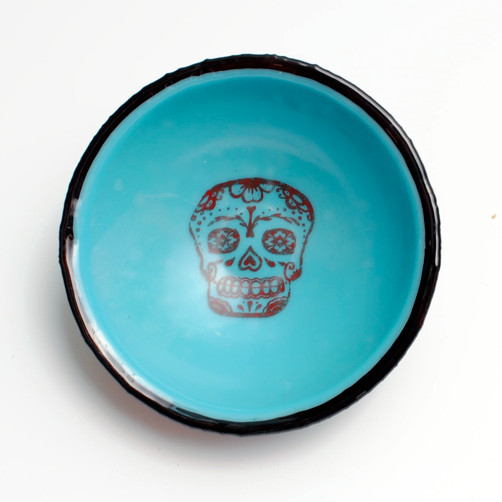 a blue bowl with a skull painted on it