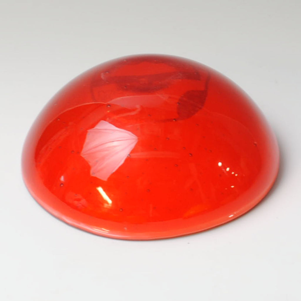 a red object sitting on top of a white table