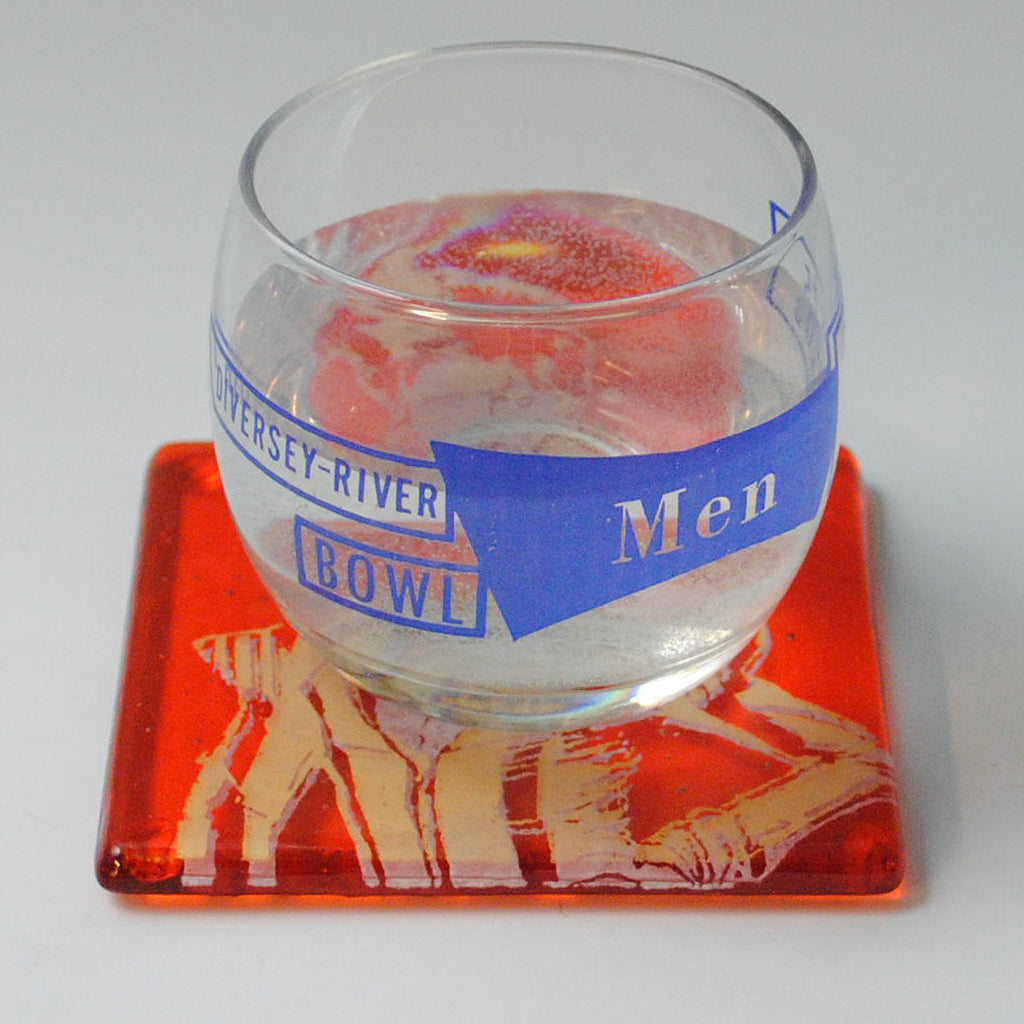 a bowl of food sitting on top of a red coaster