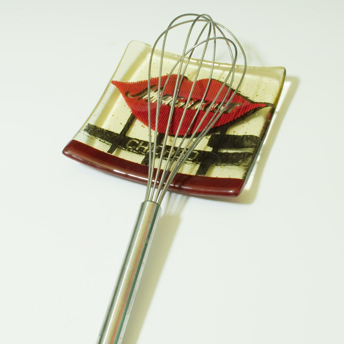 a wire whisk with a picture of a kiss on it