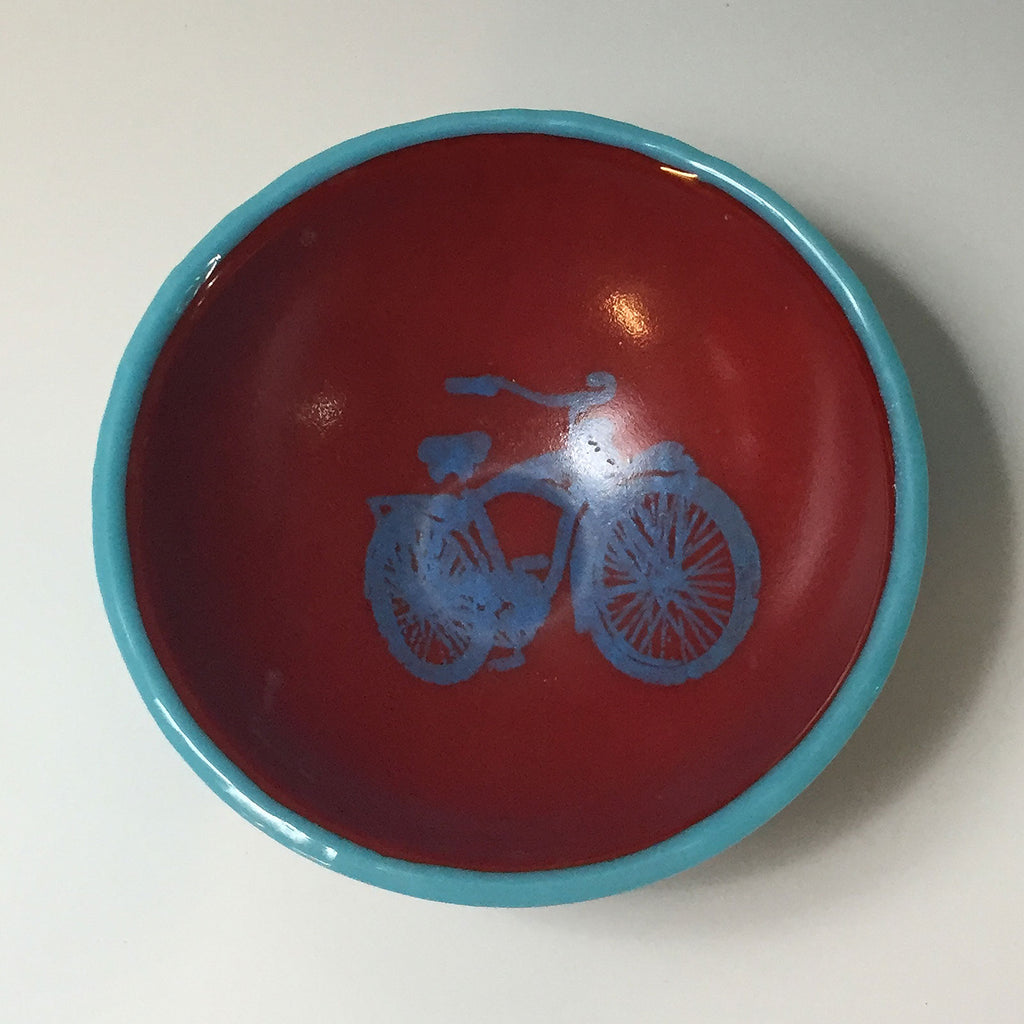 a red and blue bowl with a bicycle on it