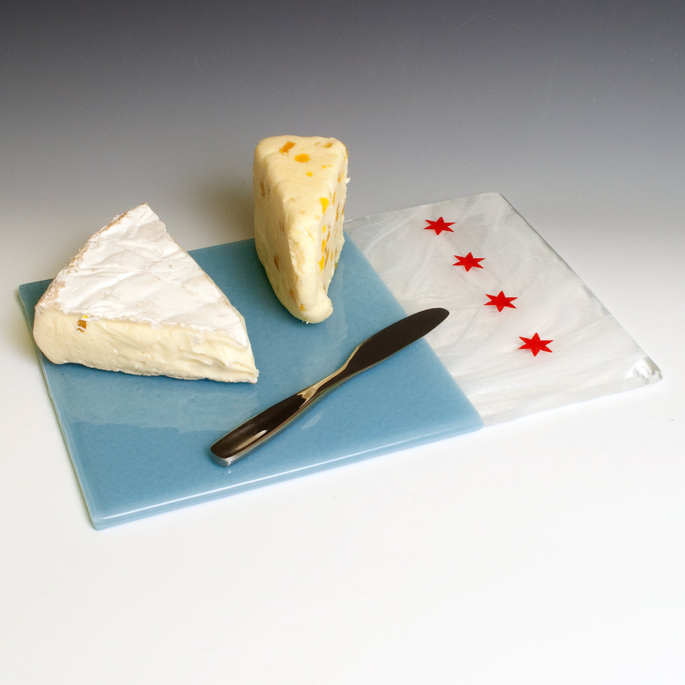 a piece of cheese sitting on top of a blue plate