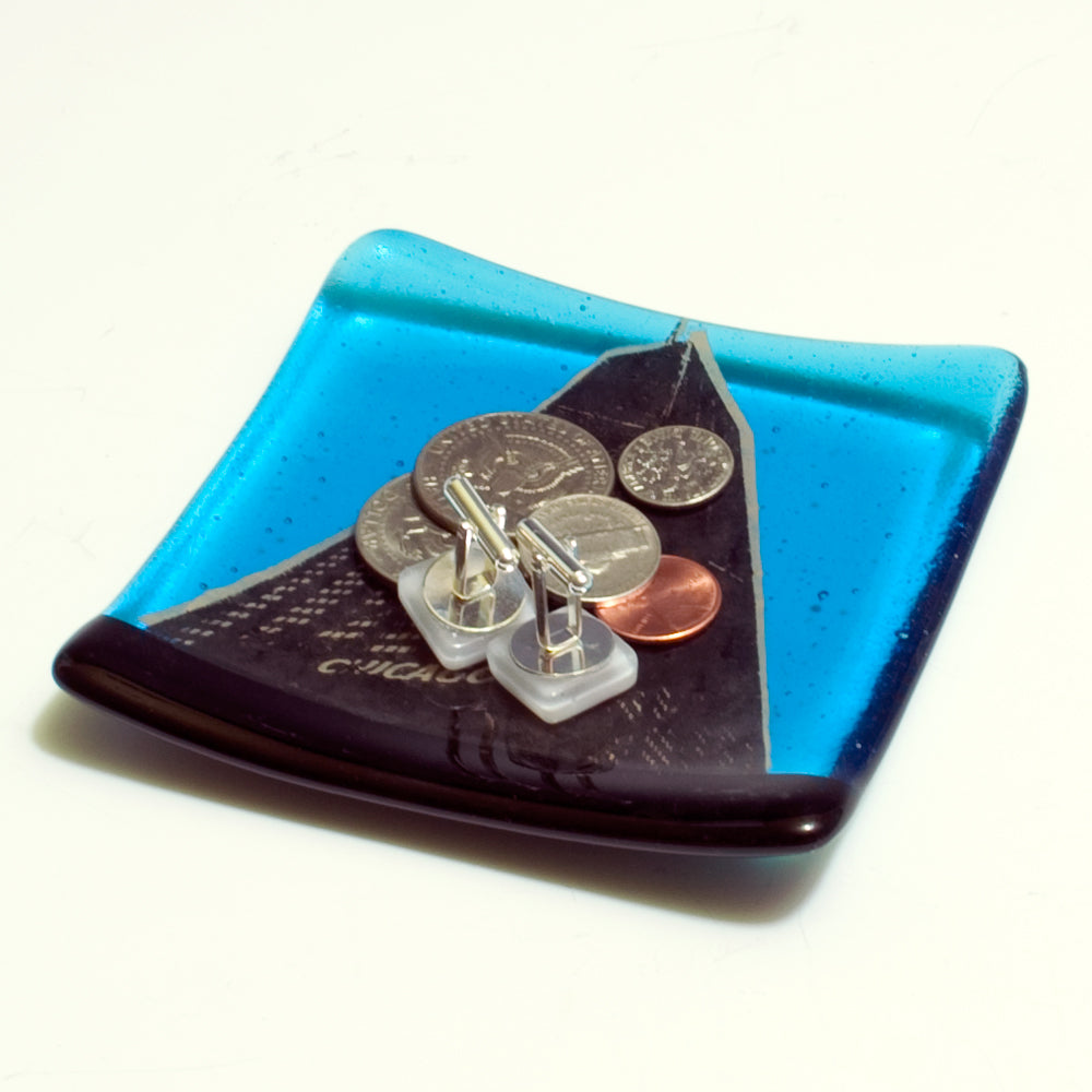 a blue plate with some coins on it