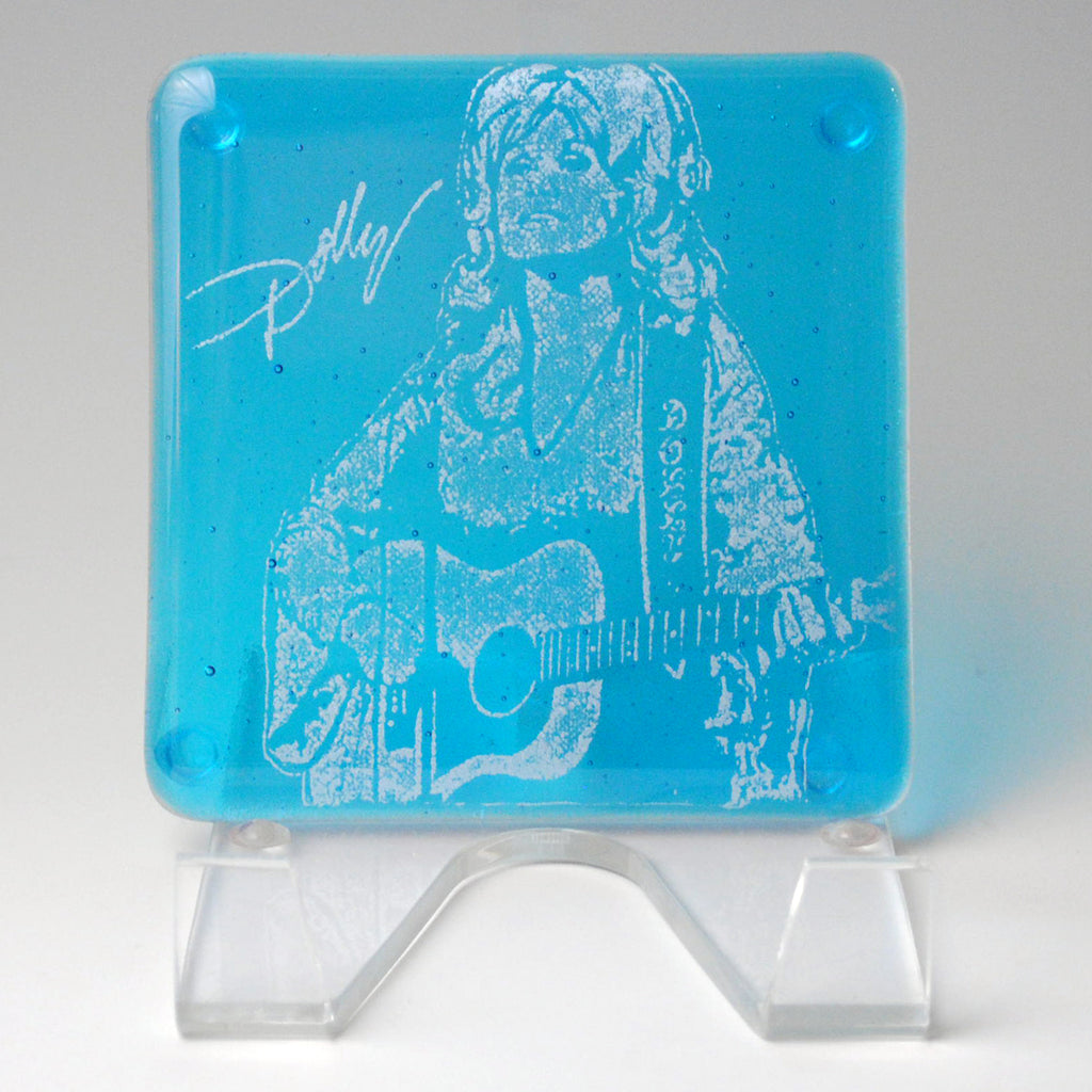 a glass block with a drawing of a woman playing a guitar