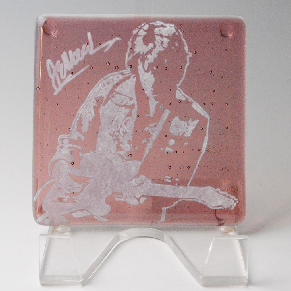 a glass block with a picture of a man playing a guitar