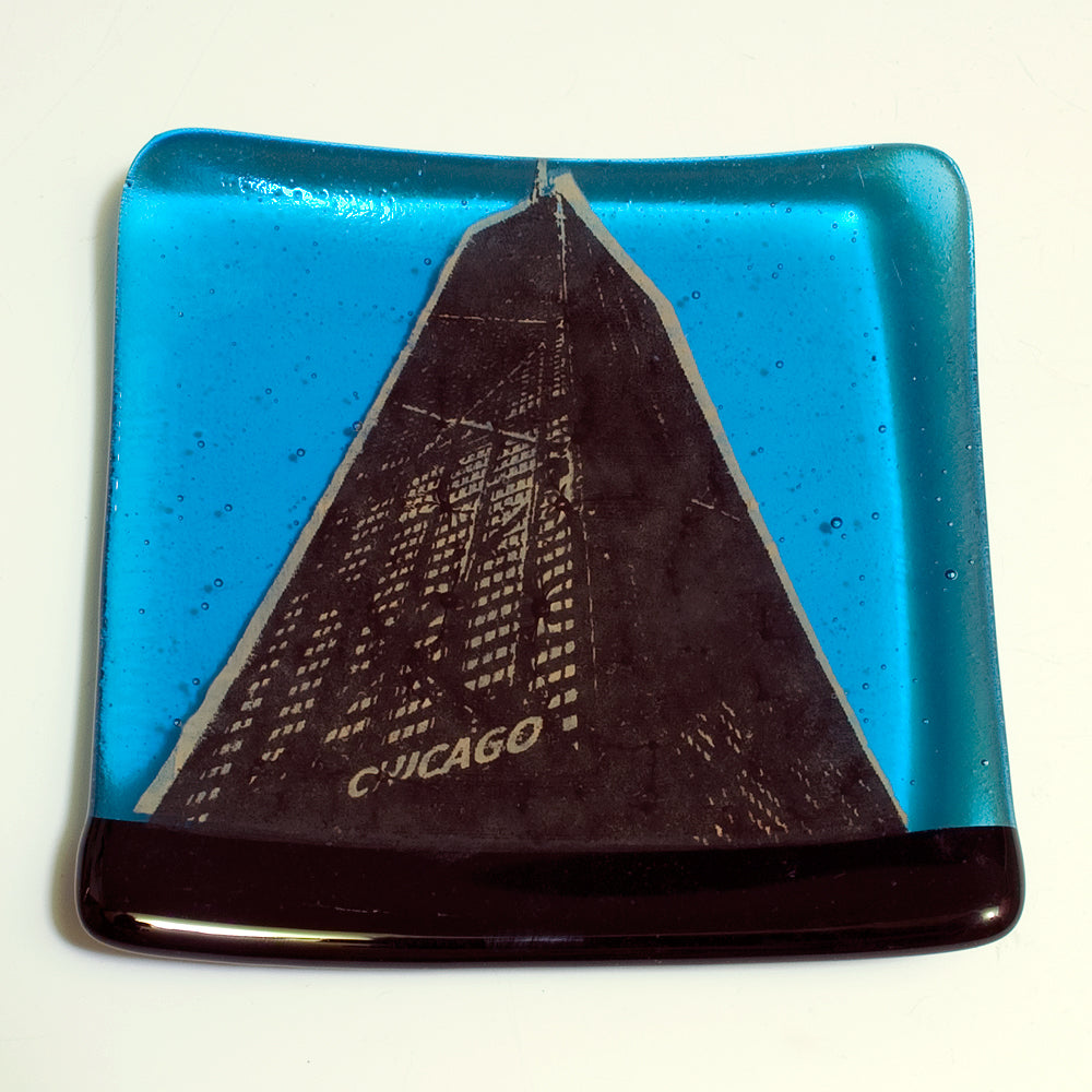 a blue plate with a picture of a building on it