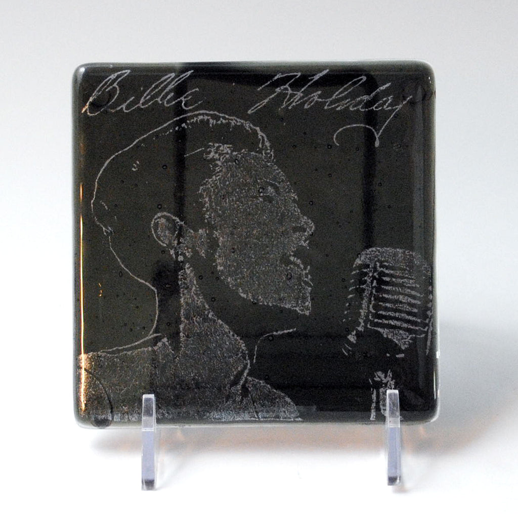 a glass plaque with a drawing of a man holding a microphone